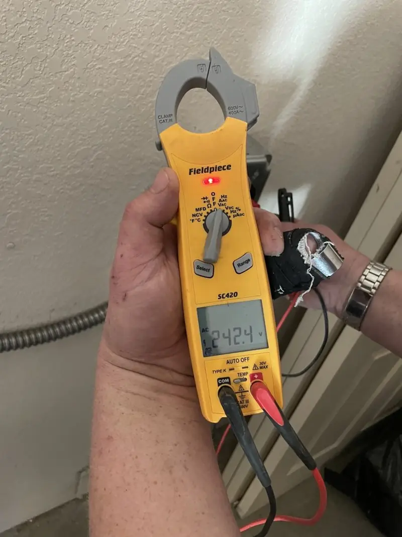 Voltage testing with clamp meter during Recessed Lighting Installation in Montrose